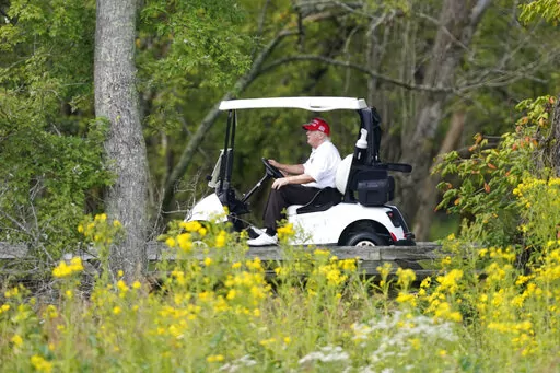 Former President Donald Trump rides around his golf course at Trump National Golf Club in Sterling, Va., Monday, Sept. 12, 2022. (AP Photo/Alex Brandon)