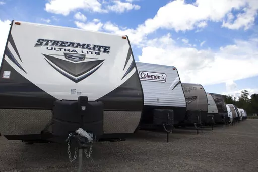 Recreational vehicles sit in a lot waiting for delivery at Horizon Transport in Wakarusa, Ind. on July 15, 2014. RV delivery is a growing trend that allows travelers to enjoy all of the conveniences of staying in an RV without actually having to drive it. Several companies offer delivery services for customers who rent, which can not only be more convenient, but also more affordable. (James Buck/The Elkhart Truth via AP)