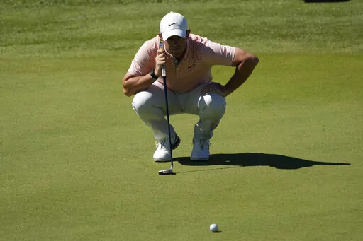 Rory McIlroy of Northern Ireland checks his golfball during the Italian Open golf tournament in Guidonia Montecelio, near Rome, Italy, Sunday, Sept. 18, 2022. The Italian Open took place on the Marco Simone course that will host the 2023 Ryder Cup. (AP Photo/Alessandra Tarantino)