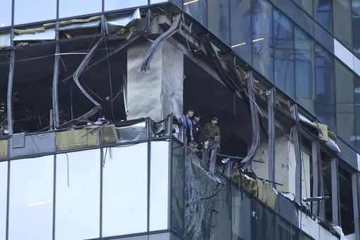 Investigators examine a damaged skyscraper in the "Moscow City" business district after a reported drone attack in Moscow, Russia, early Sunday, July 30, 2023. (AP Photo)