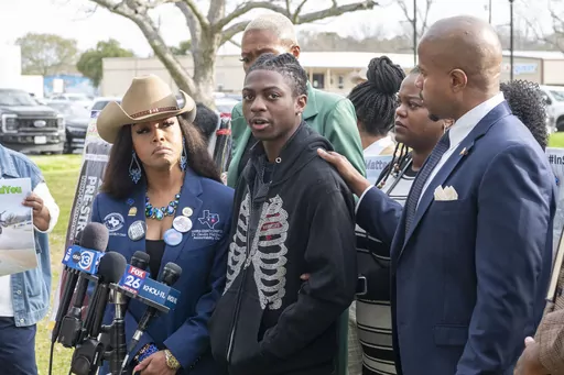 Dr. Candice Matthews, left, listens as state representative Ron Reynolds, right, with Darryl George, center, makes comments before a hearing regarding George's punishment for violating school dress code policy because of his hair style, Thursday Feb. 22, 2024 at the Chambers County Courthouse in Anahuac, Texas. A judge has ruled that George's monthslong punishment by his Texas school district for refusing to change his hairstyle does not violate a new state law prohibiting race-based hair discri