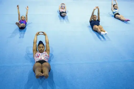 Panamanian gymnast Hillary Heron stretches as she trains for the Olympics at the No Limits Gymnastics Center in Panama City, Saturday, June 15, 2024, ahead of the Games in Paris. Stretching can help make you more flexible, improve range of motion in your joints — and feel good. (AP Photo/Matias Delacroix, File)