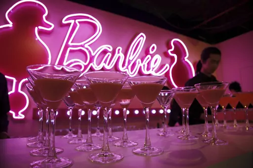 Barbie cocktails are prepared for guests at the opening ceremony of Barbie Shanghai flagship store, March 6, 2009, in Shanghai, China. The color pink has long been associated with the Barbie brand — she even has her own Pantone color. (AP Photo/Eugene Hoshiko, File)