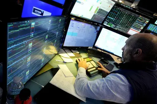 Specialist James Denaro works at his post on the floor of the New York Stock Exchange on June 12, 2024. Global shares were mixed on Friday, June 14, 2024, after Wall Street touched fresh records, with benchmarks pushed higher by the frenzy over artificial intelligence technology. (AP Photo/Richard Drew, File)