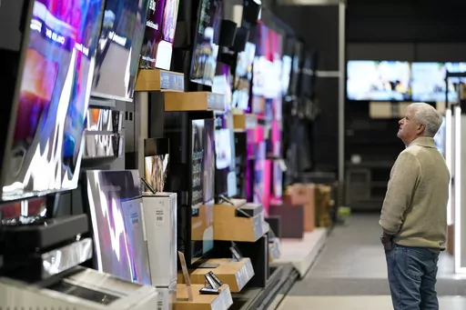 A customer browses televisions at a Best Buy store on Black Friday, Friday, Nov. 24, 2023, in Charlotte, N.C. If you’re planning on grabbing groceries or doing some other shopping this New Year’s Day, it’s wise to double check stores’ hours. (AP Photo/Erik Verduzco, File)