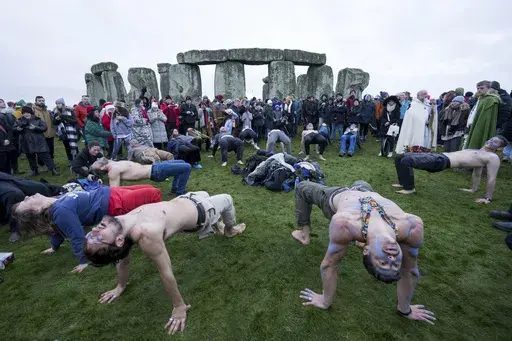 People tale part in the winter Solstice celebrations at Stonehenge, England, Saturday, Dec. 21, 2024. (AP Photo/Anthony Upton)
