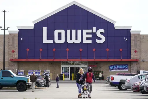 Shoppers walk in the lot of a Lowe's home improvement store in Philadelphia, Wednesday, Nov. 17, 2021. (AP Photo/Matt Rourke, File)