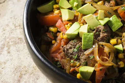 This image released by Milk Street shows a recipe for Chilean beef with tomato and corn saute. (Milk Street via AP)