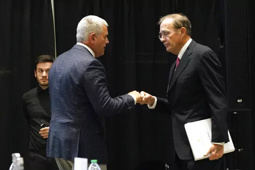Mississippi Republican House Speaker Philip Gunn of Clinton, left, fist bumps Lt. Gov. Delbert Hosemann at the Mississippi Economic Council's annual "Hobnob Mississippi" in Jackson, Miss., Oct. 27, 2022. Gunn says he wants legislators to eliminate the Mississippi income tax during the 2023 session. Hosemann, who is also a Republican, says he favors an income tax rebate. (AP Photo/Rogelio V. Solis, File)