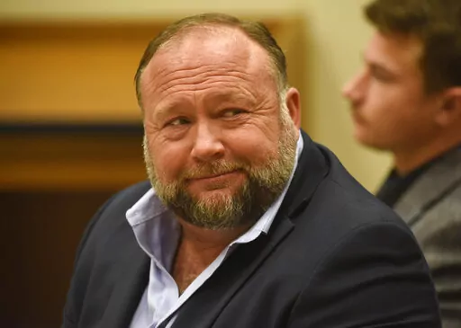 Infowars founder Alex Jones appears in court to testify during the Sandy Hook defamation damages trial at Connecticut Superior Court in Waterbury, Conn. Thursday, Sept. 22, 2022. Jones was found liable last year by default for damages to plaintiffs without a trial, as punishment for what the judge called his repeated failures to turn over documents to their lawyers. The six-member jury is now deciding how much Jones and Free Speech Systems, Infowars’ parent company, should pay the families for