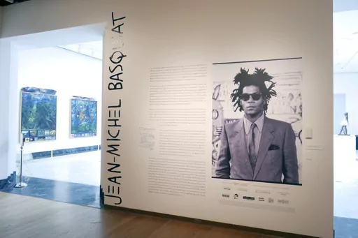 The entrance to an exhibit by artist Jean-Michel Basquiat is seen at the Orlando Museum of Art, June 1, 2022, in Orlando, Fla. On Monday, Aug. 14, 2023, the central Florida art museum which was raided last year by the FBI over an exhibit of what turned out to be forged Jean-Michel Basquiat paintings filed suit against its former executive director and others, claiming they were part of a plan to profit from the sale of the fake artwork. (AP Photo/John Raoux, File)