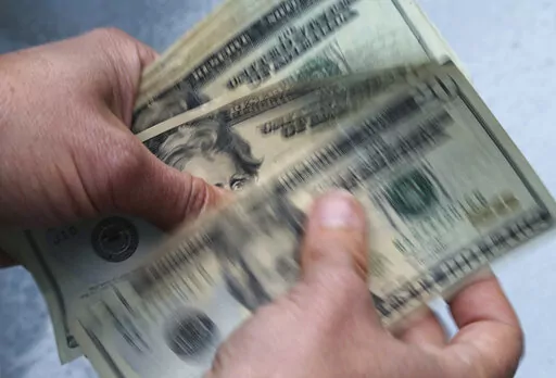 FILE- In this June 15, 2018, file photo, twenty dollar bills are counted in North Andover, Mass. Nearly a quarter of millennials (22%) are living with their parents, and more than half of those living with them (55%) made the move in 2022, according to a December survey. (AP Photo/Elise Amendola, File)