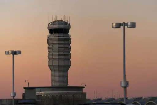 The air traffic control tower at Ronald Reagan Washington National Airport is seen at sunset, Saturday, Feb. 1, 2025, in Arlington, Va.. (AP Photo/Jose Luis Magana, file)