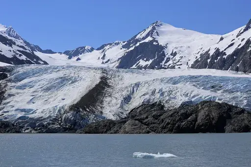 A chunk of ice floats past the Portage Glacier near Girdwood, Alaska, on June 14, 2021. (AP Photo/Mark Thiessen, file)