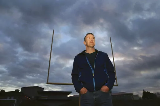 Former Bremerton High School assistant football coach Joe Kennedy stands on the field at Bremerton Memorial Stadium, Nov. 5, 2015. After the June 27, 2022 U.S. Supreme Court ruling in favor of the high school football coach’s right to pray on the field after games, there were predictions of sweeping consequences from across the ideological spectrum. But three months after the decision, there’s no sign that large numbers of coaches are following Kennedy’s high-profile example. (Larry Steaga