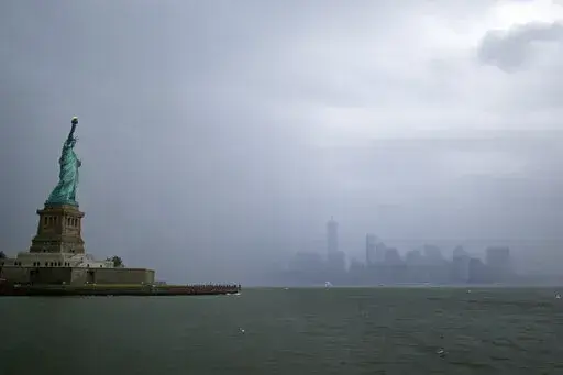 The Statue of Liberty is seen with lower Manhattan in the background July 1, 2021, in New York. There are few places in the U.S. with a more deeply ingrained reputation as a refuge for immigrants than New York City, where the Statue of Liberty rises from the harbor as a symbol of welcome for the worn and weary. (AP Photo/Adam Hunger, File)
