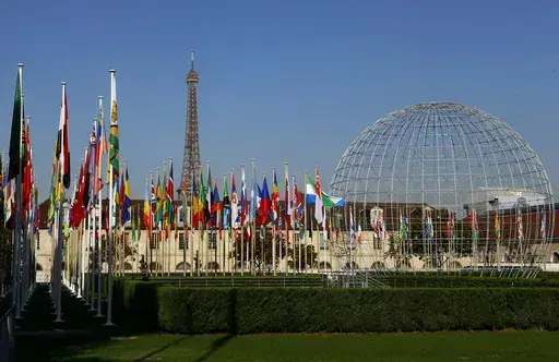 The Eiffel Tower, country flags and the Dome are seen from the garden of the United Nations Educational, Scientific and Cultural Organisation (UNESCO) headquarters building during the 39th session of the General Conference at the UNESCO headquarters in Paris. The United States is ready to rejoin the U.N. cultural and scientific agency UNESCO – and pay more than $600 million in back dues -- after a decade-long dispute sparked by the organization's move to include Palestine as a member. (AP Phot