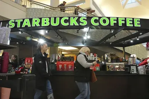 Shoppers at the Walden Galleria in Buffalo, NY, stop by the Starbucks kiosk on Saturday, Nov. 30, 2024. (AP Photo/Gene J. Puskar, File)