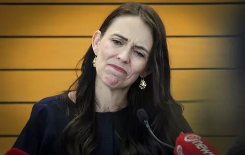 New Zealand Prime Minister Jacinda Ardern grimaces as she announces her resignation at a press conference in Napier, New Zealand Thursday, Jan. 19, 2023. Ardern says that she will not contest this year's general elections. (Warren Buckland/New Zealand Herald via AP)