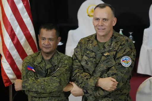 U.S. Marine Corps Major General Eric Austin, right, U.S. exercise director representative, and Philippine Army Major General Marvin Licudin, Philippine exercise director pose after the opening ceremonies of a joint military exercise flag called "Balikatan," a Tagalog word for "shoulder-to-shoulder," at Camp Aguinaldo military headquarters Tuesday, April 11, 2023, in Quezon City, Philippines. The United States and the Philippines on Tuesday launch their largest combat exercises in decades that wi