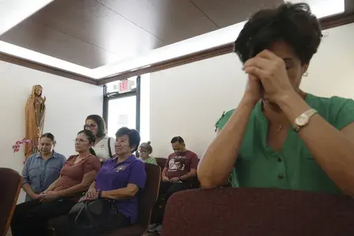 Luisa Arguello, second from right, and other parishioners pray in the perpetual adoration chapel at St. Benedict Catholic Church in Hialeah, Fla., on Thursday, March 20, 2025. (AP Photo/Marta Lavandier)