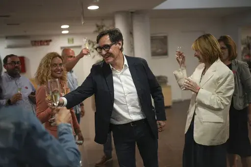 Socialist candidate Salvador Illa makes a toast with members of his team and party colleagues after the announcement of the results of elections to the Catalan parliament in Barcelona, Sunday May 12, 2024. The Socialists led by former health minister Illa won a majority of 42 seats, up from their 33 seats in 2021 when they also barely won the most votes but were unable to form a government. They will still need to earn the backing of other parties to put Illa in charge.(AP Photo/Emilio Morenatti