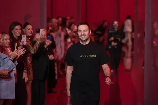 Sabato De Sarno, creative director of Gucci, accepts applause after the Gucci Spring Summer 2025 collection, that was presented in Milan, Italy, Sept. 20, 2024. (AP Photo/Luca Bruno, File)