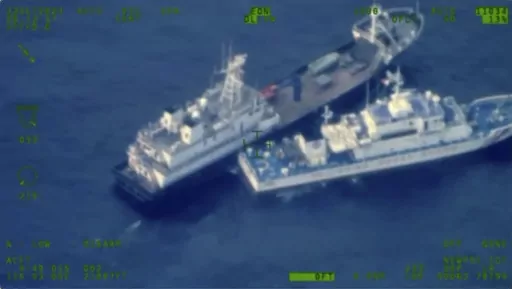 This image released by the Armed Forces of the Philippines, shows a Chinese militia vessel, top, and Philippine coast guard vessel BRP Cabra as they approach Second Thomas Shoal, locally called Ayungin Shoal, at the disputed South China Sea on Sunday Oct. 22, 2023. (Armed Forces of the Philippines via AP)