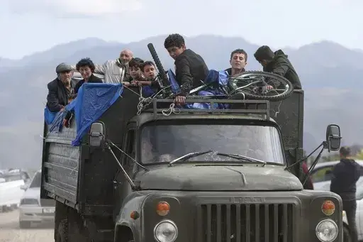 Ethnic Armenians from Nagorno-Karabakh travel on a truck on their way to Kornidzor, Armenia, on Sept. 26, 2023. Israel has quietly helped fuel Azerbaijan’s campaign to recapture Nagorno-Karabakh, officials and experts say, supplying powerful weapons to Azerbaijan ahead of its lightening offensive last month that brought the Armenian enclave in its territory back under its control.(Stepan Poghosyan, Photolure photo via AP, File)