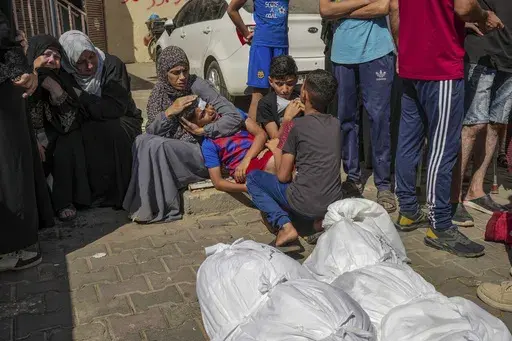 Palestinians mourn their relatives killed in the Israeli bombardment of the Gaza Strip in a hospital in Deir al Balah on Tuesday, June 18, 2024. (AP Photo/Abdel Kareem Hana)