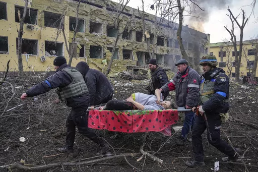 FILE- Iryna Kalinina, 32, an injured pregnant woman, is carried from a maternity hospital that was damaged during a Russian airstrike in Mariupol, Ukraine, on 9 March 2022. Associated Press photographer Evgeniy Maloletka won the World Press Photo of the Year award on Thursday, April 20, 2023, for this harrowing image of emergency workers carrying a pregnant woman through the shattered grounds of a maternity hospital in the Ukrainian city of Mariupol in the chaotic aftermath of a Russian attack. 