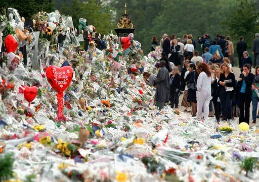 Mourners file past the tributes left in memory of Diana Princess of Wales at Kensington Palace in London, Friday, Sept. 5, 1997. It was a warm Saturday evening and journalists had gathered at a Paris restaurant to enjoy the last weekend of summer. At sometime past midnight, phones around the table began to ring all at once. News desks were contacting reporters and photographers to alert them that Princess Diana’s car had crashed in the Pont de l’Alma tunnel in Paris. That's how the news unfo