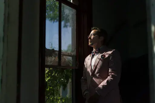 Scout, a transgender man who uses one name, stands in the entrance to his home in Providence, R.I., Wednesday, June 8, 2022. The 2020 census questionnaire drove Scout crazy. With no direct questions about sexual orientation and gender identity, it made him feel invisible, not worth including in the U.S. head count. (AP Photo/David Goldman)