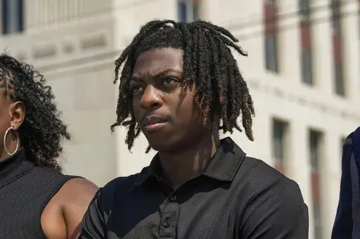 Darryl George stands next to his mother, Darresha George, in front of Galveston County Court House, May 23, 2024, in Galveston, Texas. A federal judge on Friday, Oct. 4, 2024 denied a request by Darryl George, a Black high school student in Texas for a court order that the student’s lawyers say would have allowed him to return to his high school without fear of having his previous punishment over his hairstyle resume.(Raquel Natalicchio/Houston Chronicle via AP, File)
