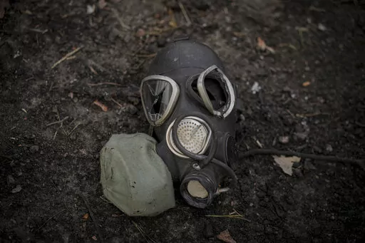 A damaged gas mask lies on the pavement at a Russian position which was overran by Ukrainian forces, outside Kyiv, Ukraine, March 31, 2022. Russia’s assault on Ukraine and its veiled threats of using nuclear arms have policymakers questioning how the West should respond to a Russian battlefield explosion of a nuclear bomb. The default U.S. policy answer, say some architects of the post-Cold War nuclear order, is with discipline and restraint. (AP Photo/Vadim Ghirda, File)
