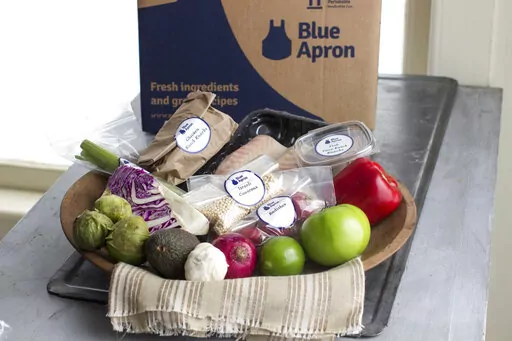 This Oct. 6, 2014, file photo shows an example of a home-delivered meal from Blue Apron. Meal kit subscriptions shot up in popularity in 2020, but many customers don’t stay past the initial promotional period. Though a full-price subscription may be more expensive than going to the grocery store, the variety of recipes, convenience of delivery and enticing promotional prices may make a subscription worth the cost, even just temporarily. ( AP Photo/Matthew Mead, File)