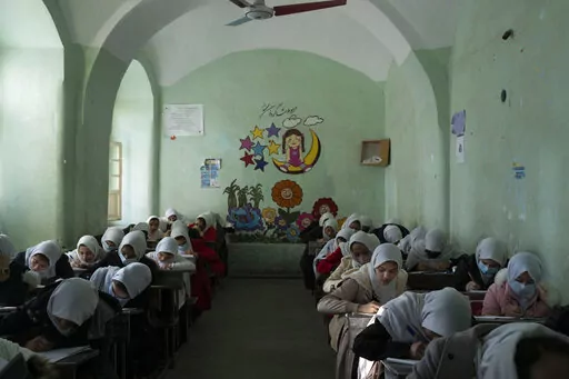 Afghan girls participate a lesson inside a classroom at Tajrobawai Girls High School, in Herat, Afghanistan, Nov. 25, 2021. Taliban hard-liners are turning back the clock in Afghanistan with a flurry of repressive edicts over the past days that hark back to their harsh rule from the late 1990s. Girls have been banned from going to school beyond the sixth grade, women are turned back from boarding planes if they travel unaccompanied by a male relative. (AP Photo/Petros Giannakouris, File)