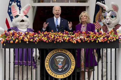 President Joe Biden, accompanied by first lady Jill Biden and Easter Bunnies, speaks on the Blue Room balcony at the White House during the White House Easter Egg Roll, April 18, 2022, in Washington. (AP Photo/Andrew Harnik, File)