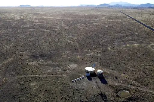 A windmill draws water for livestock in Leupp, Ariz., on the Navajo Nation, Saturday, March 9, 2024. In a vote on Thursday, May 23, 2024, the Navajo Nation Council has unanimously approved a proposed water rights settlement that carries a price tag larger than any such agreement enacted by Congress. (AP Photo/Felicia Fonseca, File)