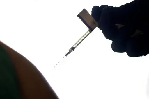 A droplet falls from a syringe after a health care worker was injected with the Pfizer-BioNTech COVID-19 vaccine at Women & Infants Hospital in Providence, R.I., on Dec. 15, 2020. On Friday, June 10, 2022, The Associated Press reported on stories circulating online incorrectly claiming that 20,000 people have died from COVID-19 vaccines. The figure misrepresents data maintained by the Centers for Disease Control and Prevention and the Food and Drug Administration. To date, a total of nine deaths