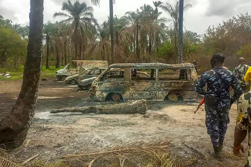 People gather Saturday April 23, 2022 at the site of an explosion that took place the day before at an illegal oil refinery in Ohaji-Egbema local government area in Imo state, southeast Nigeria. At least 100 people are feared to have died in the explosion, authorities told The Associated Press, as the search for bodies at the site and for two people suspected of being involved in the incident intensified. (AP Photo)