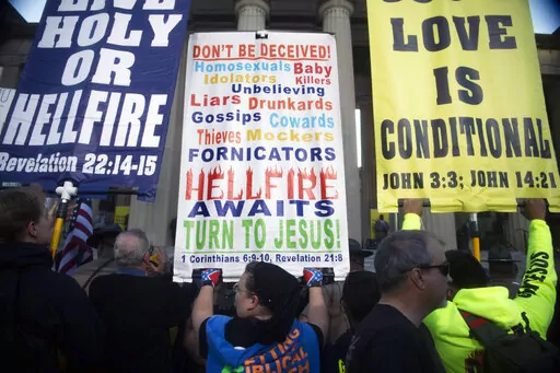 Attendees congregate at a rally against gender-affirming care at War Memorial Plaza in Nashville, Tenn., Oct. 21, 2022. Hate speech and threats of violence targeting transgender people and other LGBTQ individuals is thriving on social media and spurring fears of more violence. (Nicole Hester/The Tennessean via AP)