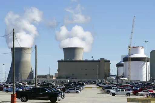 Reactors for Unit 3 and 4 sit at Georgia Power's Plant Vogtle nuclear power plant on Jan. 20, 2023, in Waynesboro, Ga., with the cooling towers of older Units 1 and 2 billowing steam in the background. Company officials announced Wednesday, May 24, 2023, that Unit 3 would reach full power in coming days, after years of delays and billions in cost overruns. (AP Photo/John Bazemore)