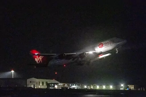 A repurposed Virgin Atlantic Boeing 747 aircraft, named Cosmic Girl, carrying Virgin Orbit's LauncherOne rocket, takes off from Spaceport Cornwall at Cornwall Airport, Newquay, England, Monday, Jan. 9, 2023. The plane will carry the rocket to 35,000 feet where it will be released over the Atlantic Ocean to the south of Ireland, as part of the Start Me Up mission and the first rocket launch from U.K. The rocket will take multiple small satellites, with a variety of civil and defence applications,