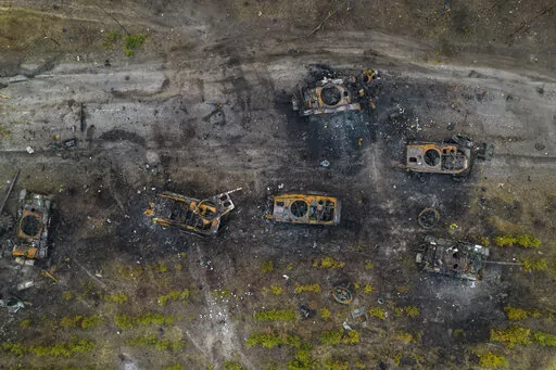 Destroyed Russian armored vehicles sit on the outskirts of Kyiv, Ukraine, March 31, 2022. In the year since Russia invaded Ukraine, disinformation and propaganda have emerged as key weapons in the Kremlin's arsenal. (AP Photo/Rodrigo Abd, File)