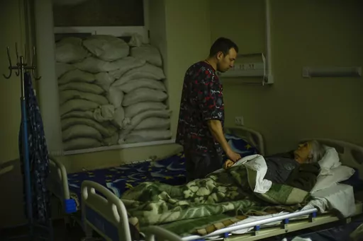 CORRECTS YEAR TO 2023 - FILE - Doctor Ivan Mozhaiev attends to a patient during morning rounds at Pokrovsk hospital in Pokrovsk, eastern Ukraine, on May 22, 2022. Fidelity Charitable, the nation’s largest grantmaker, distributed a record-setting $11.8 billion to nonprofits in 2023, up more than 5% from the previous year at a time when generally donations are dropping. Doctors Without Borders USA and St. Jude Children’s Research Hospital were the most popular charities again, as they were in 
