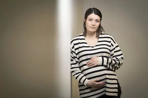 Jillaine St.Michel stands for a portrait in Boise, Idaho on Saturday, Dec. 2, 2023. A year earlier, she learned that her previous 20-week fetus had multiple genetic and developmental problems and probably wouldn’t survive. She lives in Idaho, which has a ban on abortions, so St.Michel and her husband called about 15 out-of-state clinics, finally getting on a three-week waiting list in Denver and a two-week waiting list in Seattle. Pregnant again, she is due to give birth to a boy in January. (