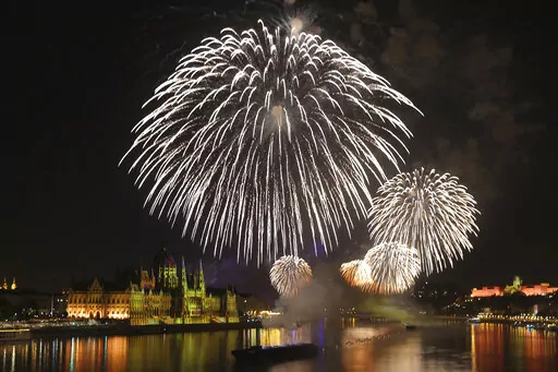 Fireworks illuminate the skies over Budapest, Hungary, Saturday, Aug. 27, 2022. An elaborate fireworks display took place Saturday under calm skies in Hungary's capital after a postponement of the show last weekend caused controversy when it led to the firing of the country's top meteorologists over their weather predictions. (AP Photo/Csaba Domotor)