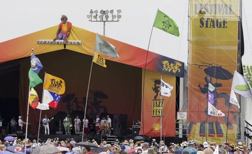Flags fly in front of the Festival Stage during the New Orleans Jazz & Heritage Festival on May 7, 2023. The Fair Grounds Race Course, which plays host to the 2024 New Orleans Jazz and Heritage Festival, begins its annual transformation in earnest Tuesday, March 26, 2024, as organizers prepare to take over the field this Spring for two weekends of music, food and fun. (Brett Duke/The Advocate via AP, File)