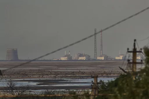 The Zaporizhzhia nuclear power plant, Europe's largest, is seen in the background of the shallow Kakhovka Reservoir after the dam collapse, in Energodar, Russian-occupied Ukraine, Tuesday, June 27, 2023. Officials at the Russian-controlled Zaporizhzhia Nuclear Power Plant said that the site was attacked Sunday April 7, 2024, by Ukrainian military drones, including a strike on the dome of the plant’s sixth power unit. (AP Photo/Libkos, File)